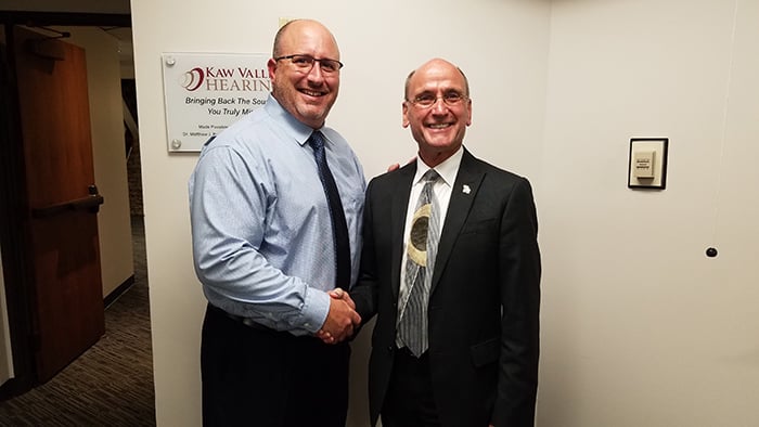 Osher Director Emeritus Jim Peters (right) thanks Matt Brown, KU alumnus and owner of Kaw Valley Hearing, for his lead gift during the Osher Institute’s fundraising drive to install a hearing loop in the Osher classroom at the St. Andrews Office Facility.